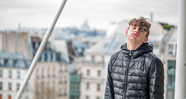 Jeune garçon agacé sur une terrasse